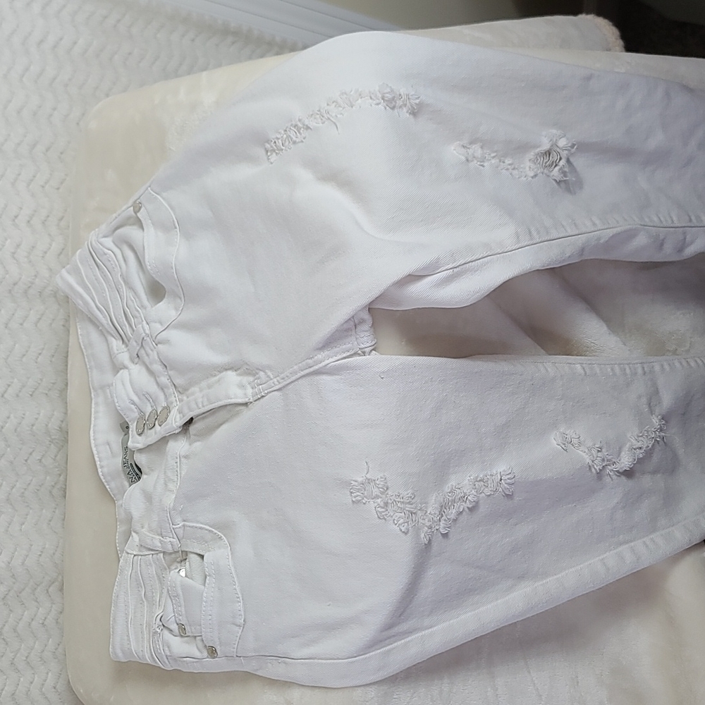 Adriana junior girls' distressed white denim jeans.